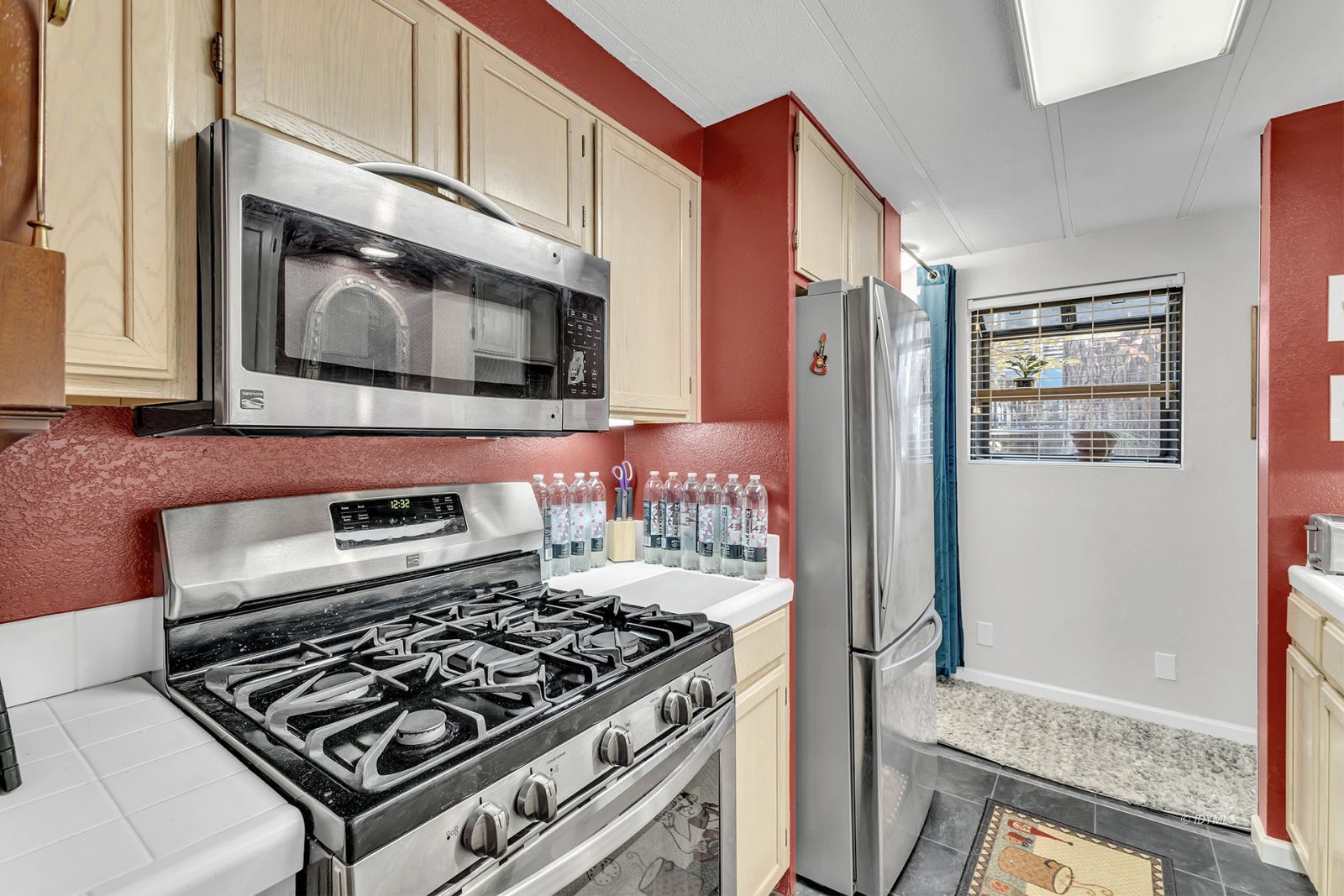 25955 Highway 243, Unit 18 Idyllwild, CA 92549 - Photo 21 of 46 a kitchen with stainless steel appliances granite countertop a stove and a microwave
