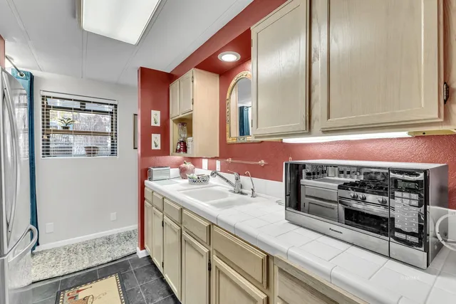 a kitchen with refrigerator and cabinets