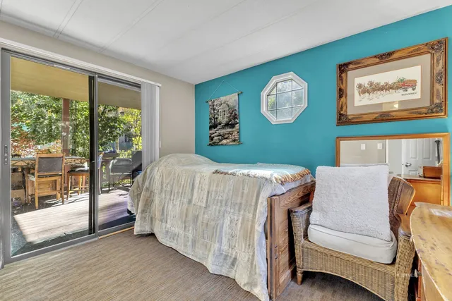 a view of hallway with closet and a mirror