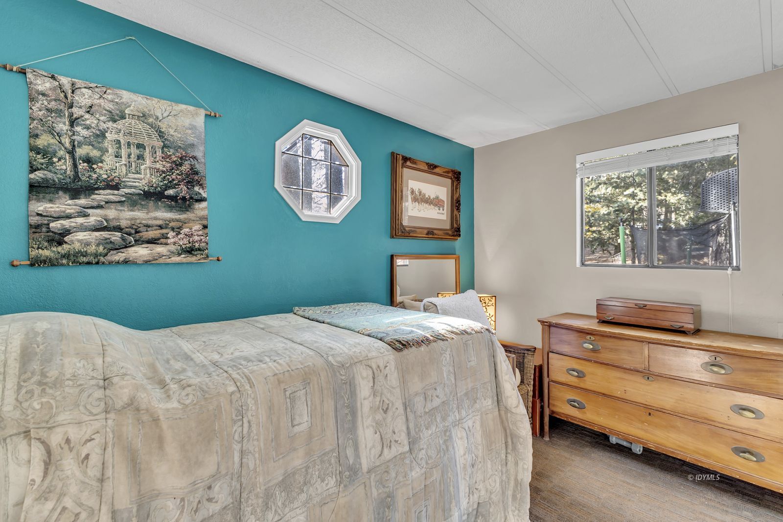 25955 Highway 243, Unit 18 Idyllwild, CA 92549 - Photo 33 of 46 a bedroom with a bed and a dresser