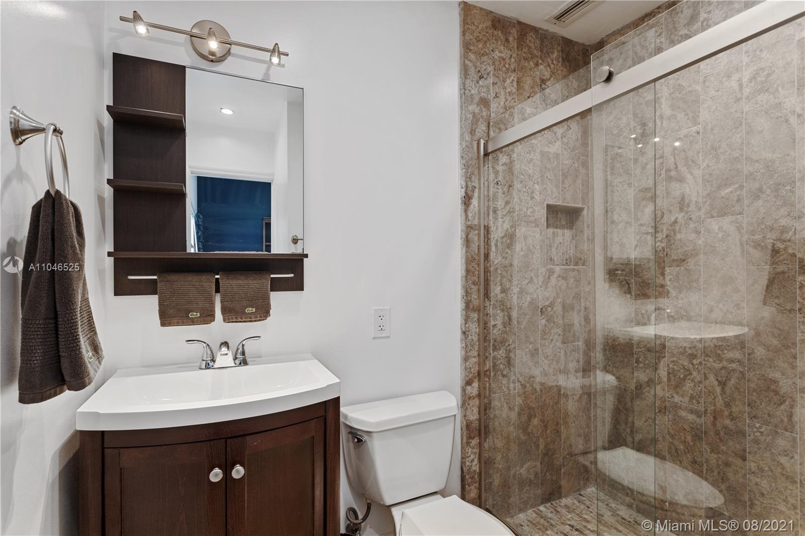 5750 Alton Road Miami Beach, FL 33140 - Photo 11 of 21 a bathroom with a sink a toilet and shower