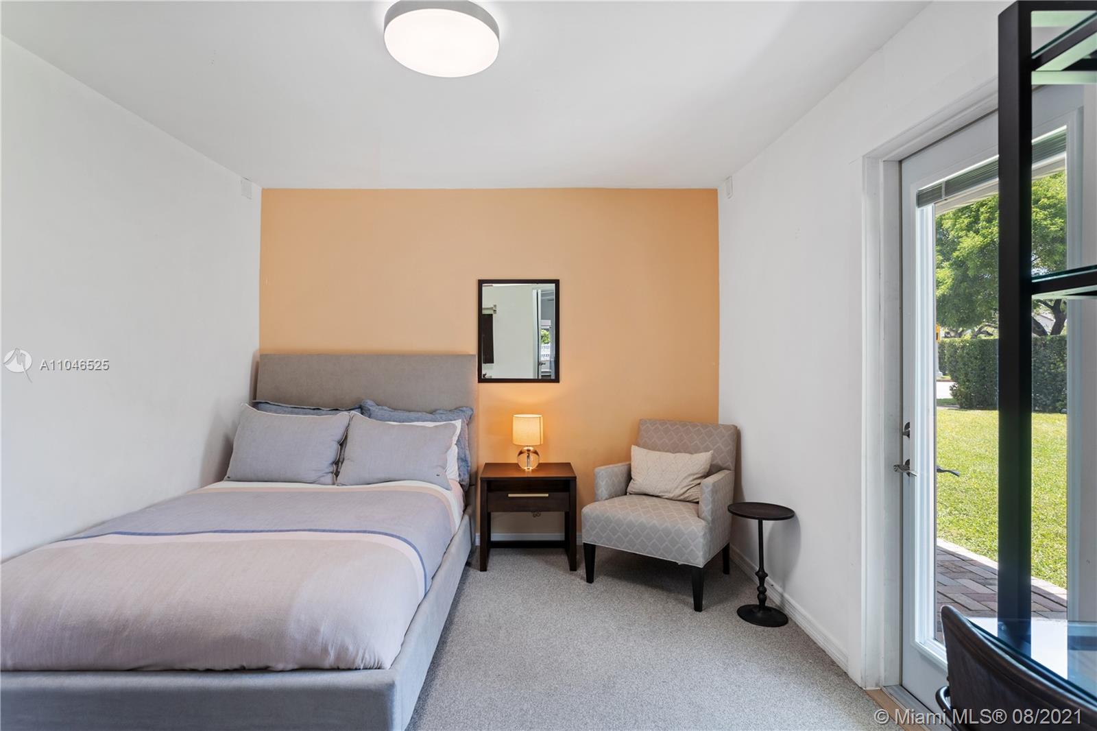 5750 Alton Road Miami Beach, FL 33140 - Photo 12 of 21 a bedroom with a bed and window