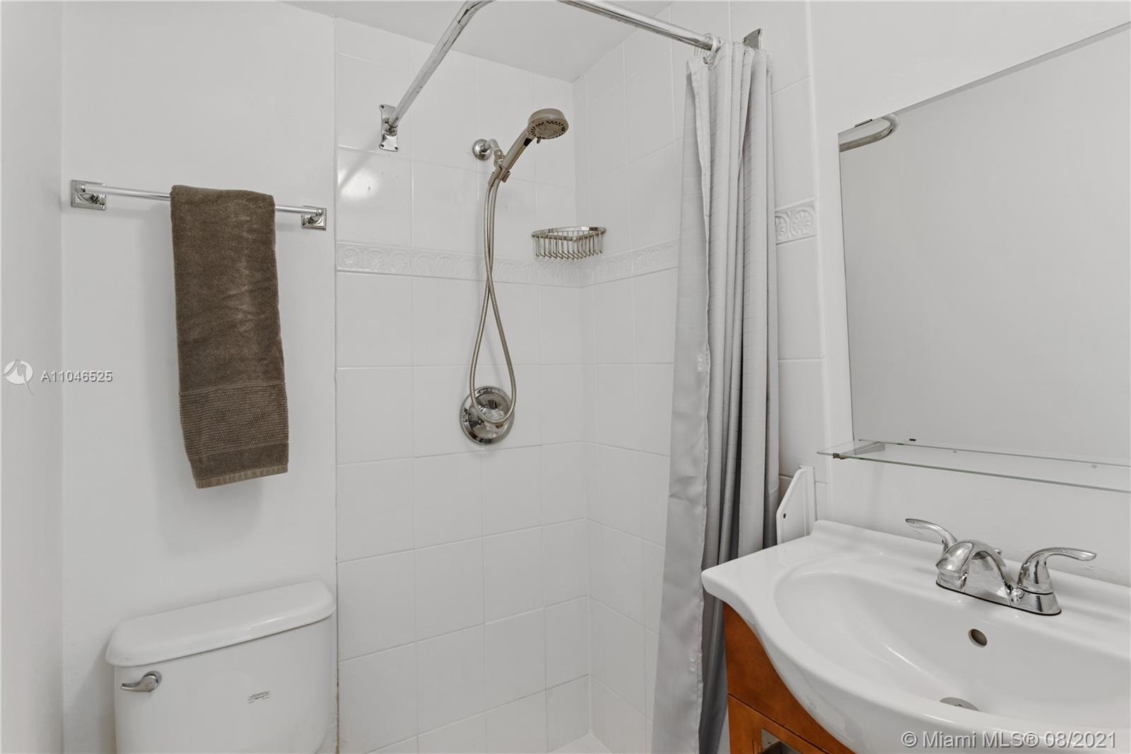 5750 Alton Road Miami Beach, FL 33140 - Photo 13 of 21 a bathroom with a sink and mirror