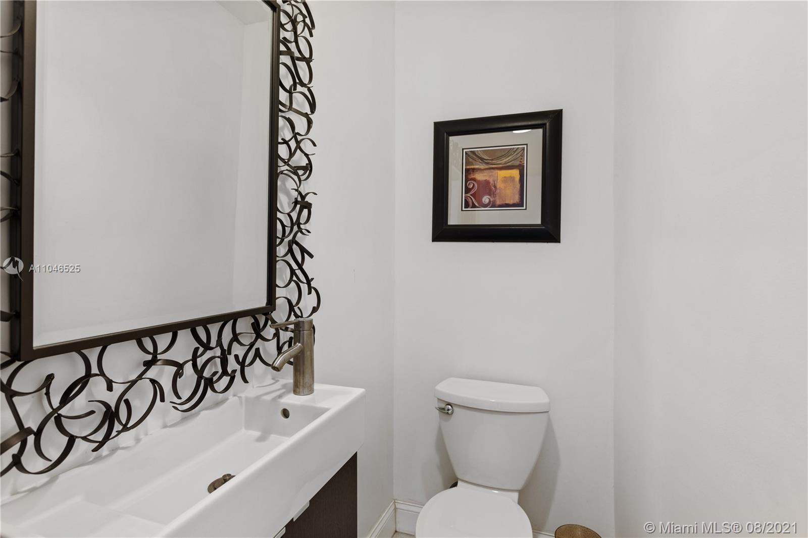 5750 Alton Road Miami Beach, FL 33140 - Photo 14 of 21 a bathroom with a toilet and a sink