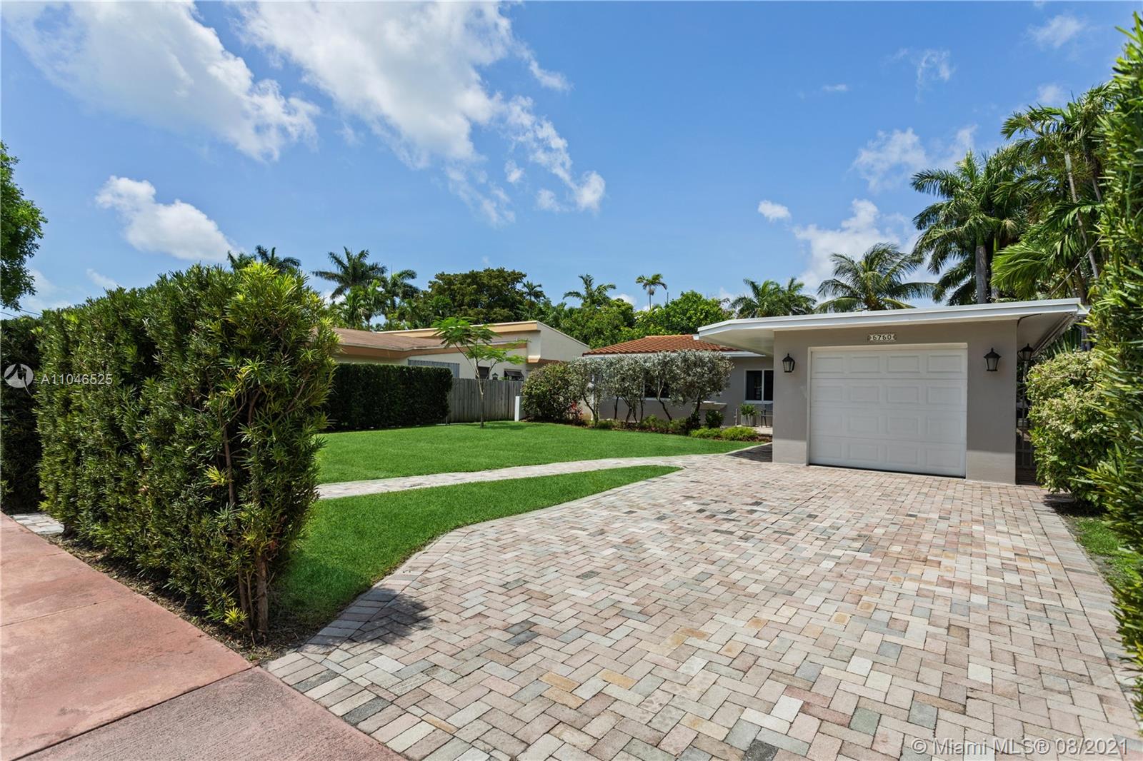 5750 Alton Road Miami Beach, FL 33140 - Photo 20 of 21 a view of a house with a yard and potted plants