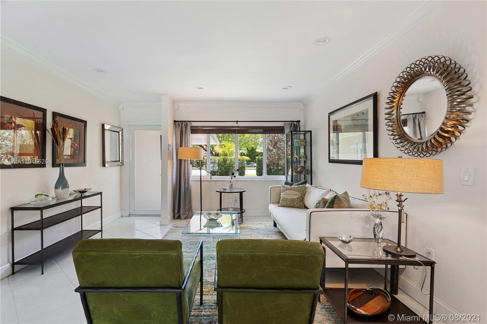 5750 Alton Road Miami Beach, FL 33140 - Photo 3 of 21 a living room with furniture and a large window