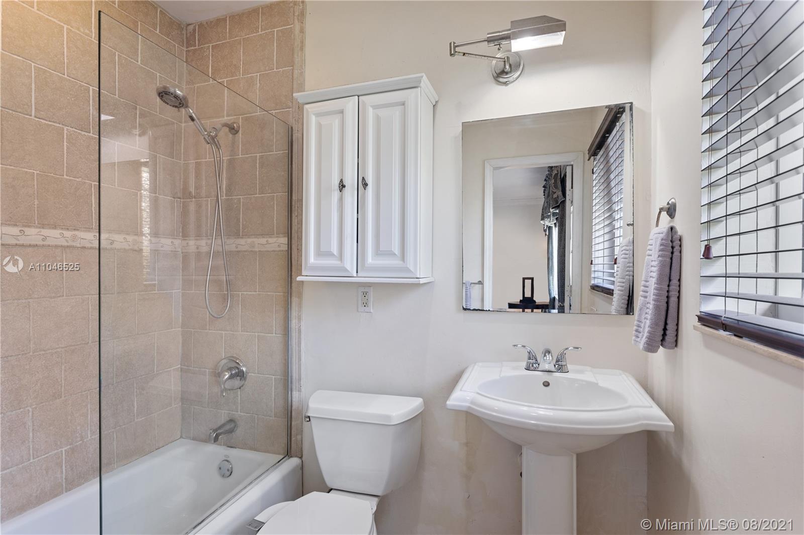 5750 Alton Road Miami Beach, FL 33140 - Photo 8 of 21 a bathroom with a sink toilet and shower