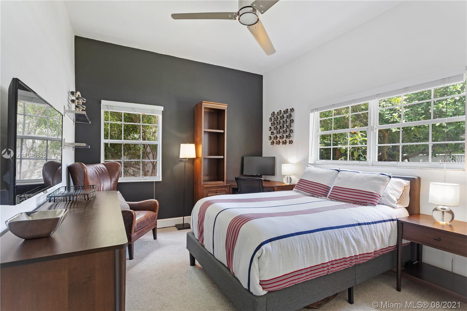 5750 Alton Road Miami Beach, FL 33140 - Photo 10 of 21 a bedroom with a bed and wooden floor
