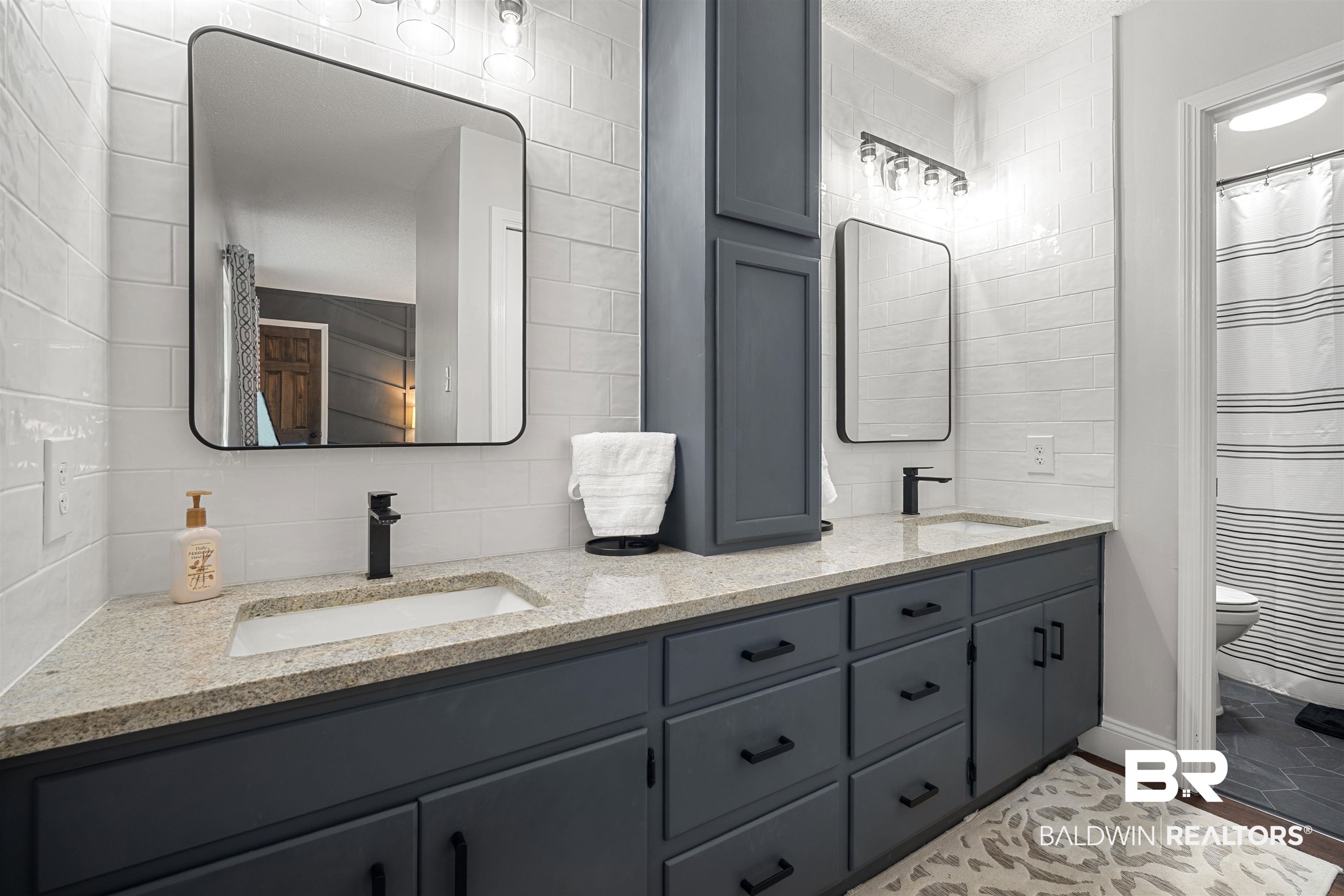 71 Caisson Trace Daphne, AL 36527 - Photo 19 of 36 Double vanity featuring granite countertops, undermount sinks, and matte black fixtures