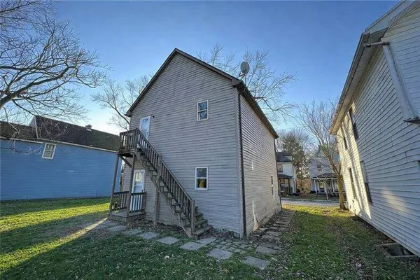 a view of backyard of house and garage