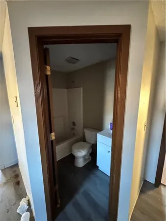 an empty room with an entrance to other door