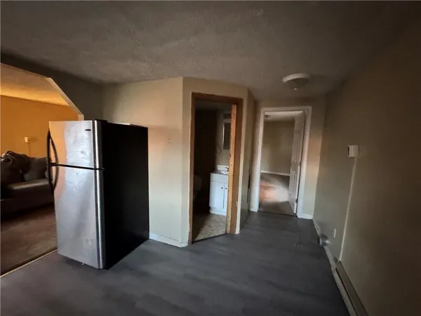 a view of a kitchen from a hallway