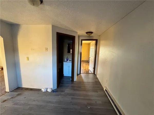 a view of a kitchen from a hallway