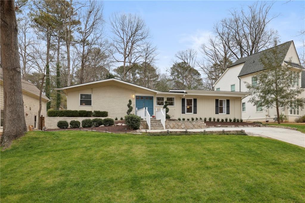 a front view of house with yard and seating area