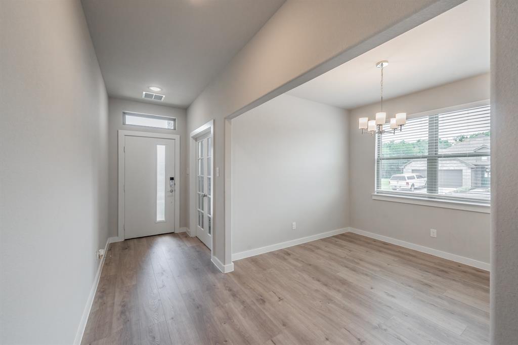 3202 Glorioso Drive Royse City, TX 75189 - Photo 16 of 40 an empty room with wooden floor and windows