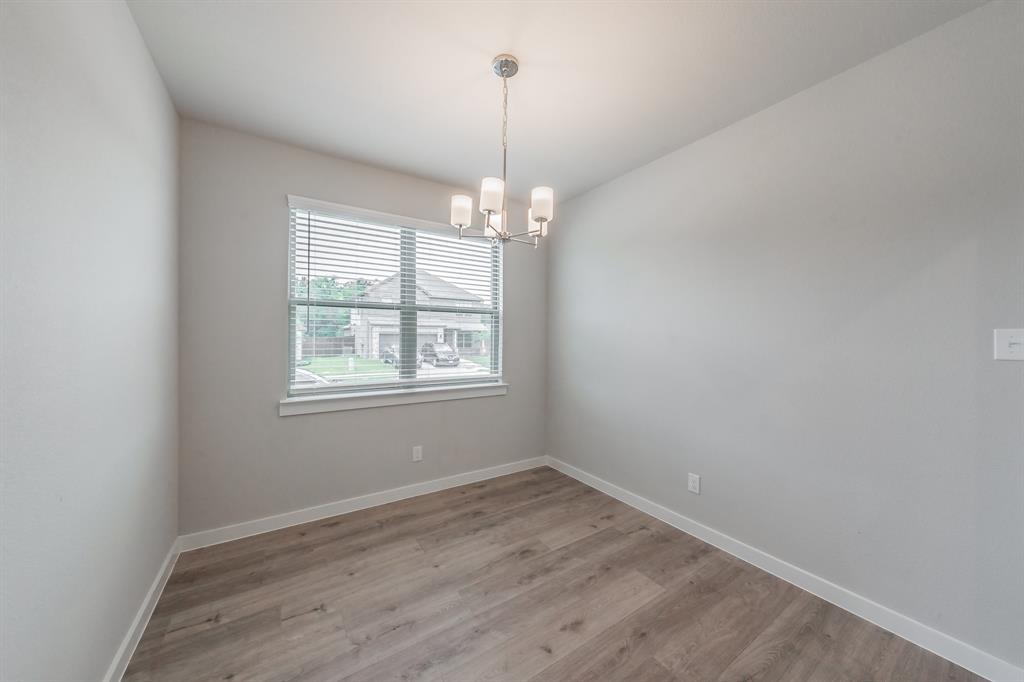 3202 Glorioso Drive Royse City, TX 75189 - Photo 17 of 40 wooden floor in an empty room with a window