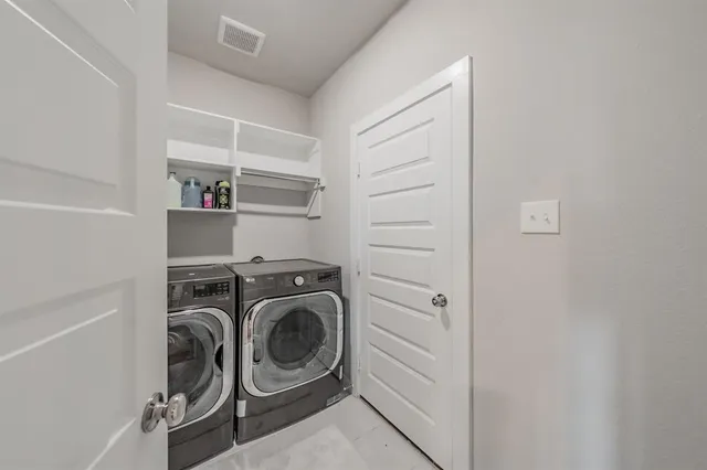 a kitchen with kitchen island white cabinets appliances and a sink