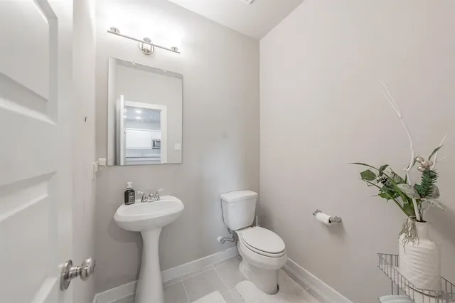 a kitchen with stainless steel appliances a dining table chairs and wooden floor