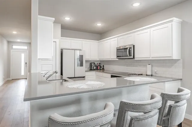 a kitchen with refrigerator and cabinets