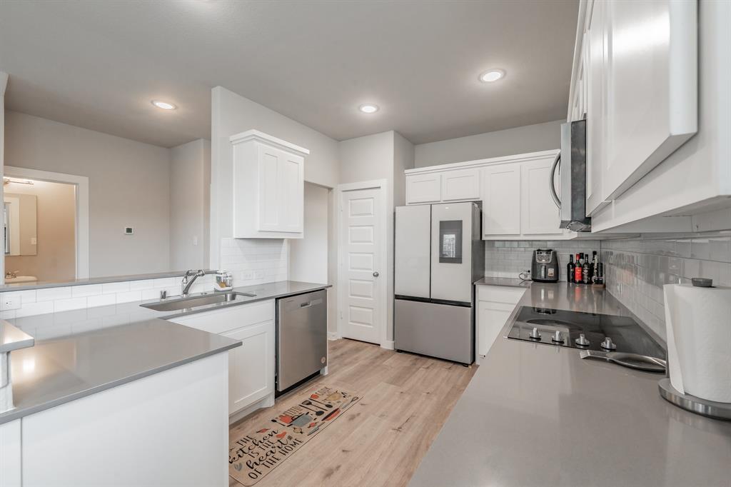 3202 Glorioso Drive Royse City, TX 75189 - Photo 25 of 40 a kitchen with refrigerator and cabinets