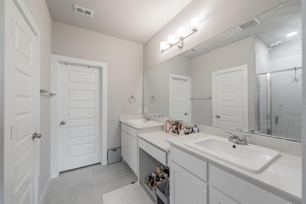3202 Glorioso Drive Royse City, TX 75189 - Photo 34 of 40 a bathroom with a double vanity sink mirror and double