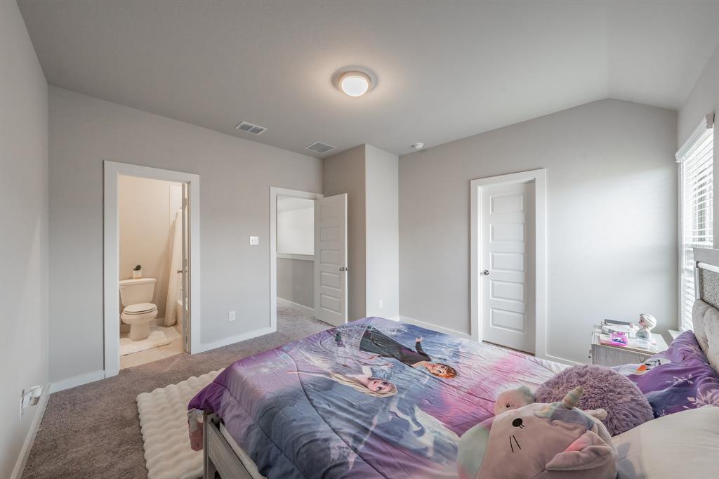 3202 Glorioso Drive Royse City, TX 75189 - Photo 39 of 40 a bedroom with a bed and a mirror