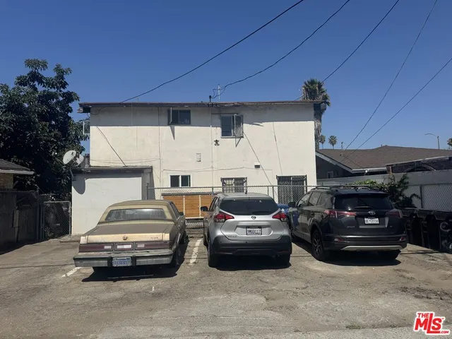 a couple of cars parked in parking area of a house