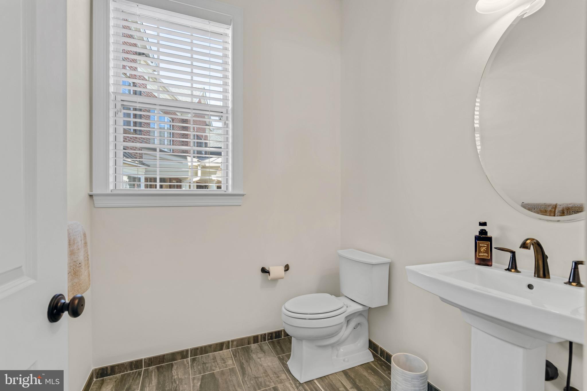 1045 Matthew Way New Castle, DE 19720 - Photo 21 of 62 a bathroom with a toilet sink vanity and a window