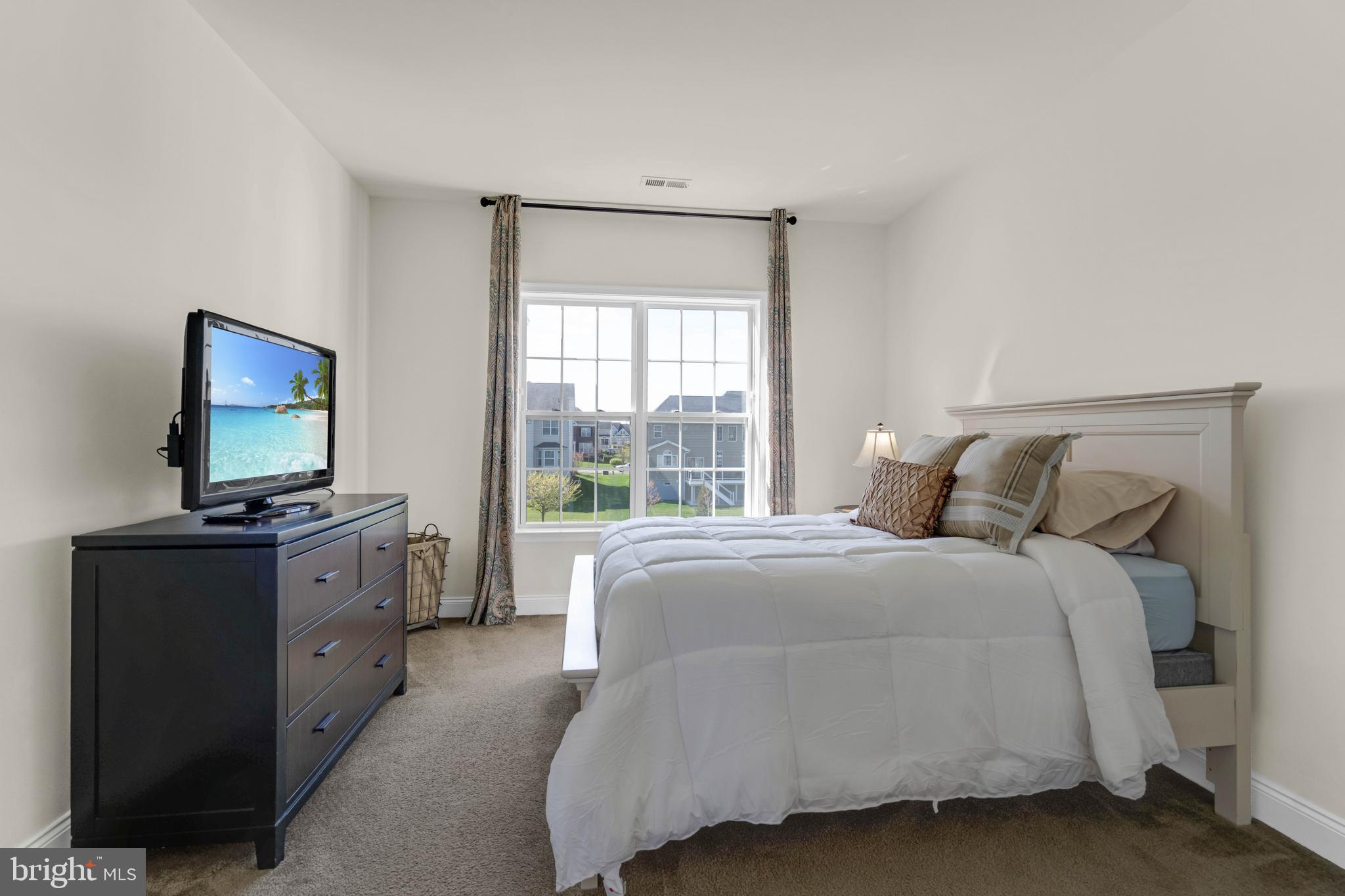 1045 Matthew Way New Castle, DE 19720 - Photo 34 of 62 a spacious bedroom with a bed and a flat screen tv