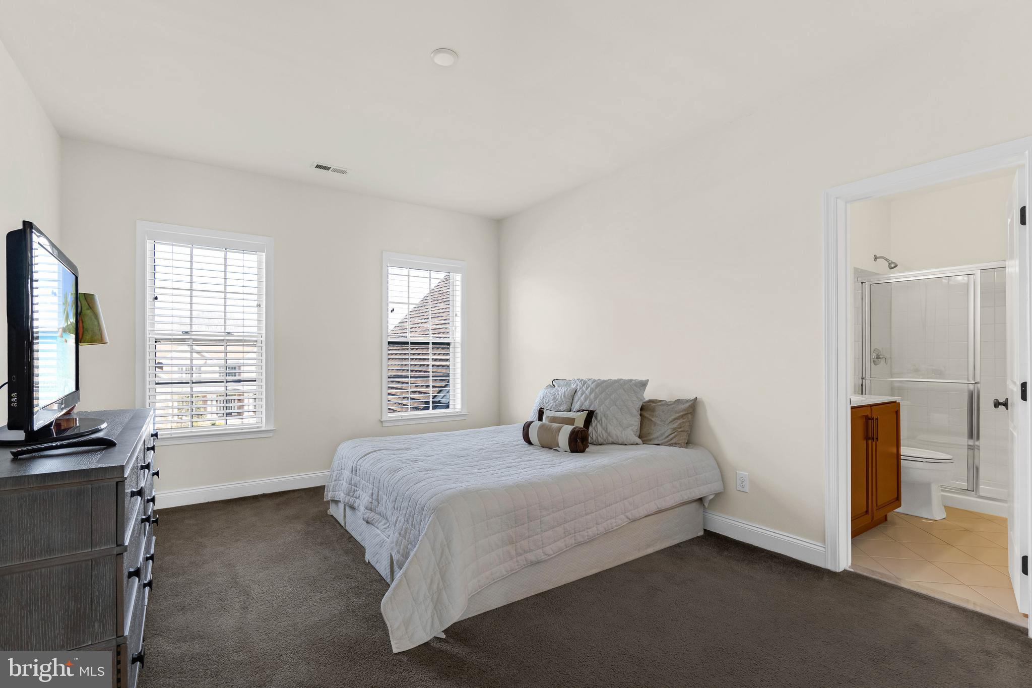 1045 Matthew Way New Castle, DE 19720 - Photo 40 of 62 a bedroom with a bed flat screen tv and windows