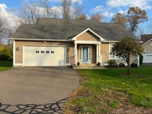a front view of a house with yard and green space