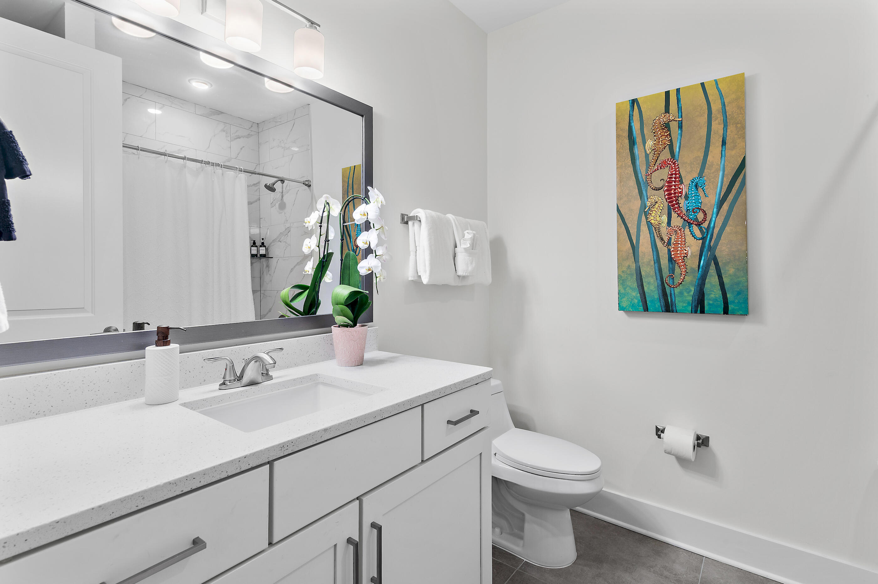 179 South County Highway 393, Unit 312 Santa Rosa Beach, FL 32459 - Photo 8 of 40 a bathroom with a sink a toilet and a mirror