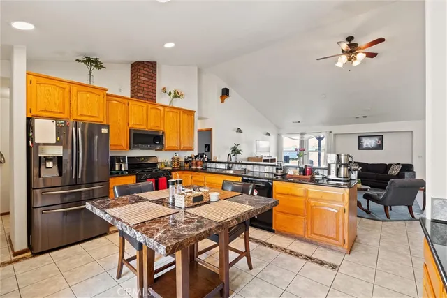 a kitchen with a table chairs stove and kitchen view