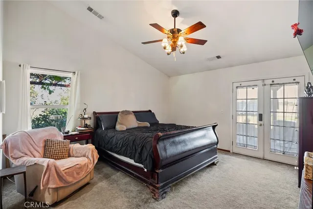 a spacious bedroom with a bed and a large window