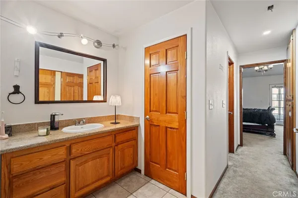 a en suite bathroom with a sink mirror and shower