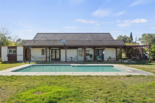 a front view of a house with a swimming pool