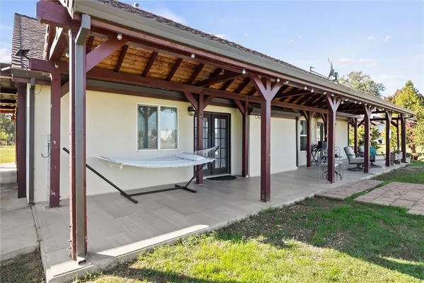 a view of a porch with a table and chairs