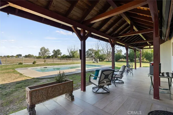 a view of a swimming pool with a table and chairs
