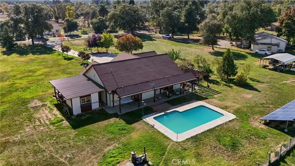 an aerial view of a house with garden space and street view