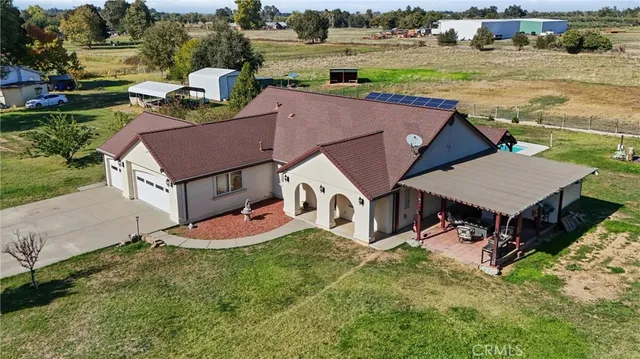 an aerial view of a house with garden space and lake view