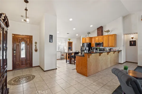a living room with furniture and kitchen view