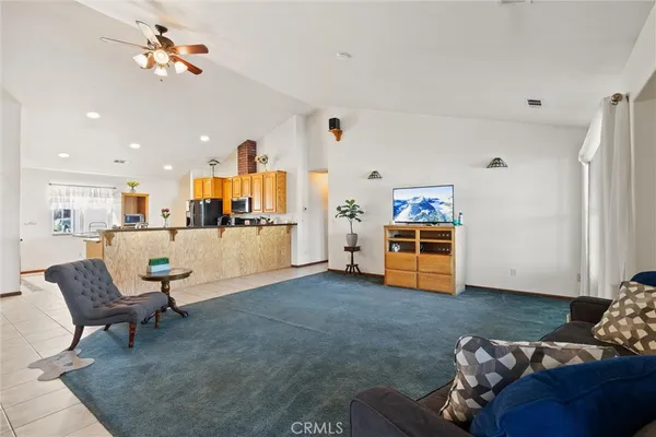a living room with furniture and kitchen view
