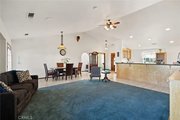 a living room with furniture and kitchen view