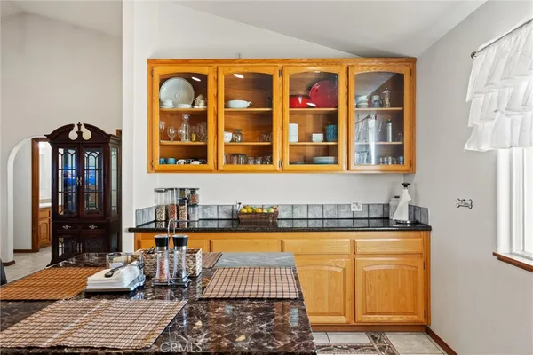 a view of a kitchen with granite countertop a barbecue grill and a yard