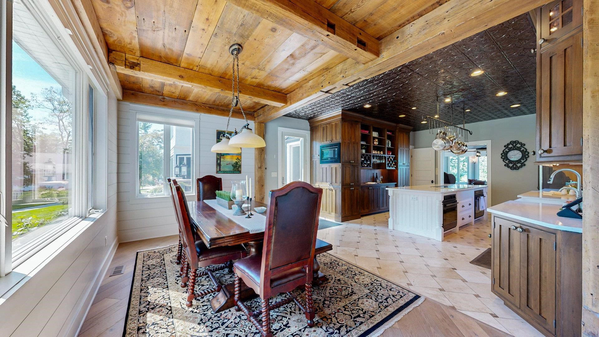 N1211 East Side Road Birchwood, WI 54817 - Photo 27 of 70 Dining room with wood walls and a wood ceiling with exposed beams
