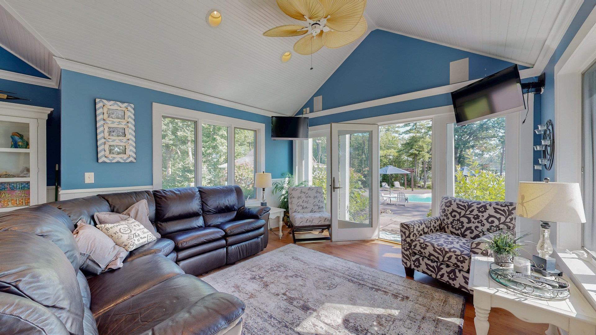 N1211 East Side Road Birchwood, WI 54817 - Photo 52 of 70 Living area featuring plenty of natural light, wood finished floors, ornamental molding, high vaulted ceiling, and a ceiling fan