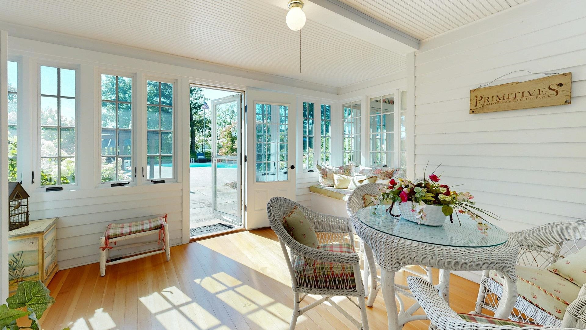 N1211 East Side Road Birchwood, WI 54817 - Photo 68 of 70 Sunroom / solarium featuring wood walls, hardwood / wood-style flooring, and beam ceiling