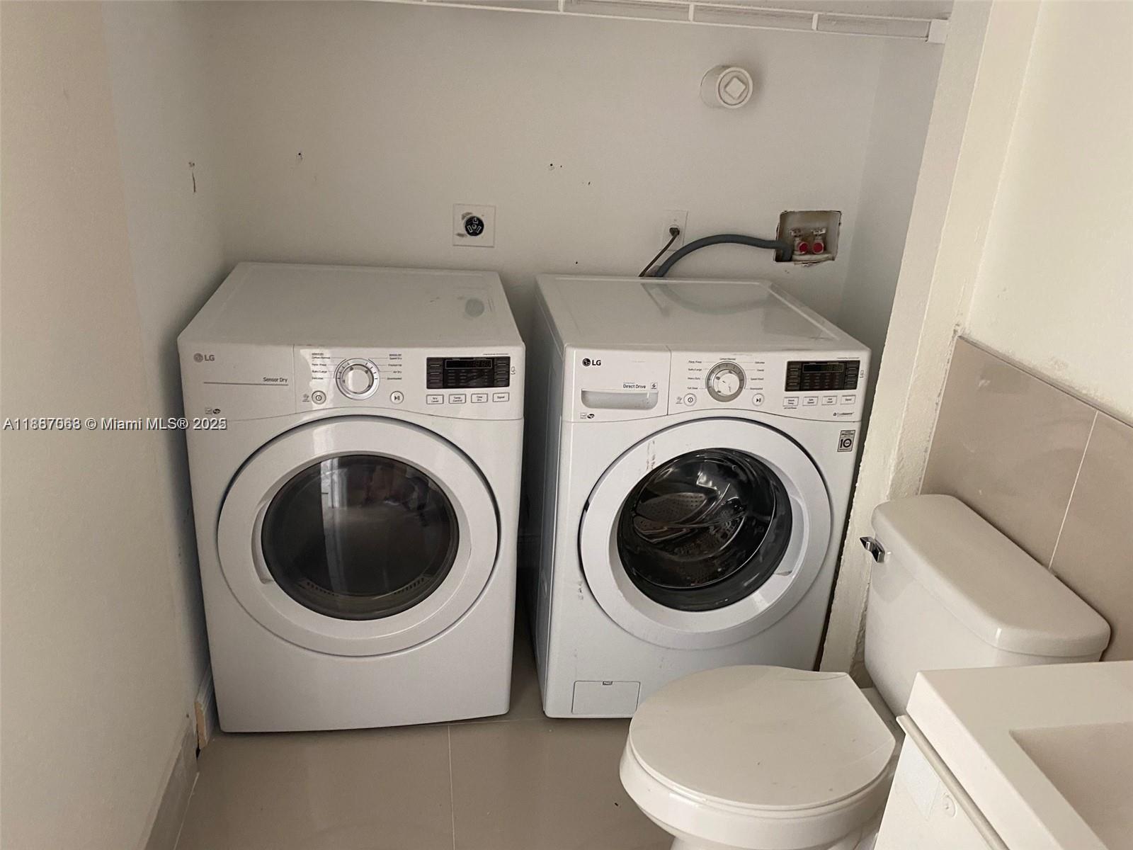 26 Crossings Circle, Unit B Boynton Beach, FL 33435 - Photo 11 of 15 a utility room with dryer and washer