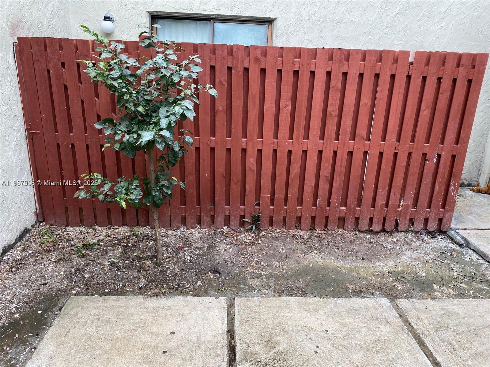 26 Crossings Circle, Unit B Boynton Beach, FL 33435 - Photo 13 of 15 a view of a backyard with wooden fence
