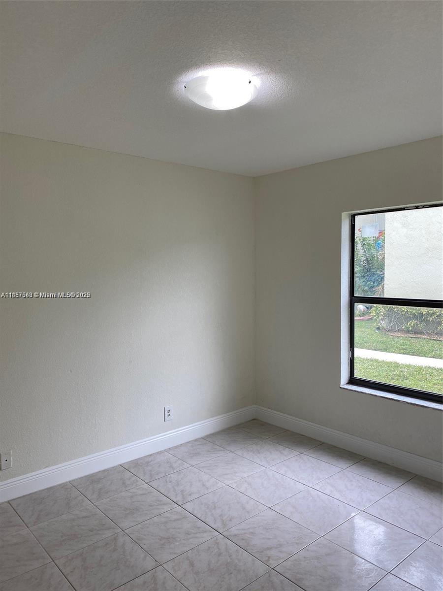 26 Crossings Circle, Unit B Boynton Beach, FL 33435 - Photo 4 of 15 a view of an empty room with a window